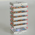Egg incubator with multiple trays of eggs on a gray background